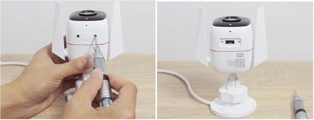 For an outdoor Tapo security camera, loosen the screws on the back panel using a screwdriver to remove the cover, then locate the RESET button inside the camera housing.