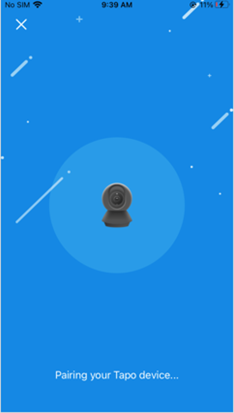 Tapo app pairing screen showing camera icon with "Pairing your Tapo device..." message on blue background.