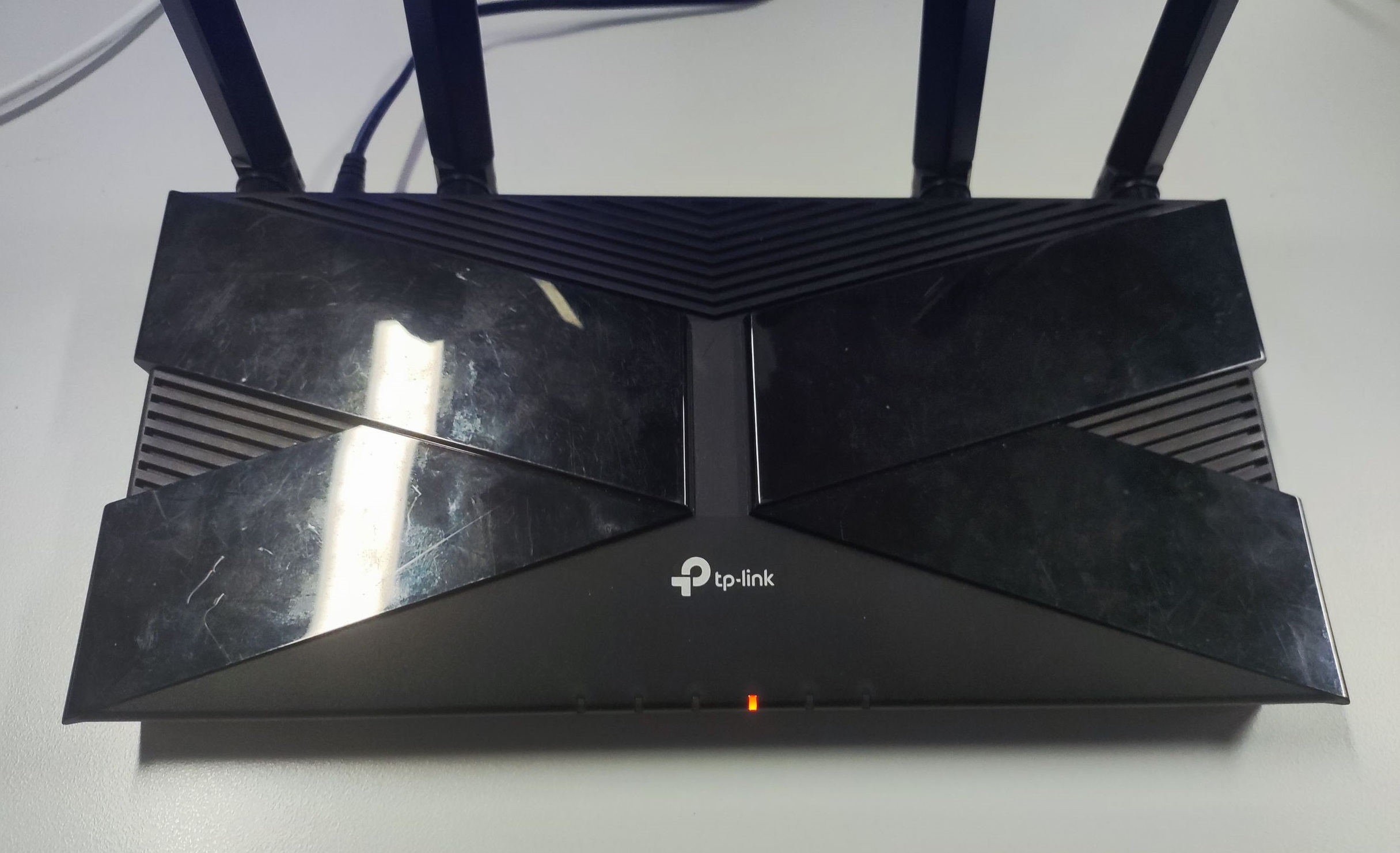 TP-Link AX router showing only the middle LED lit orange after holding WPS button during power on.
