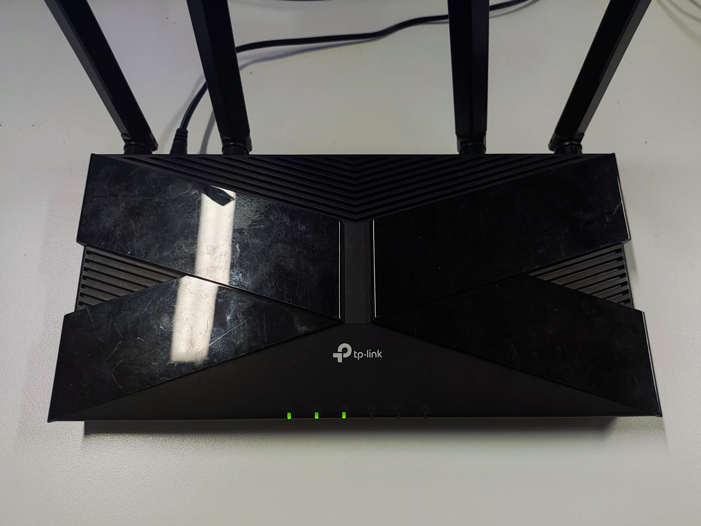 TP-Link AX router with all LEDs stable, indicating firmware recovery is complete.