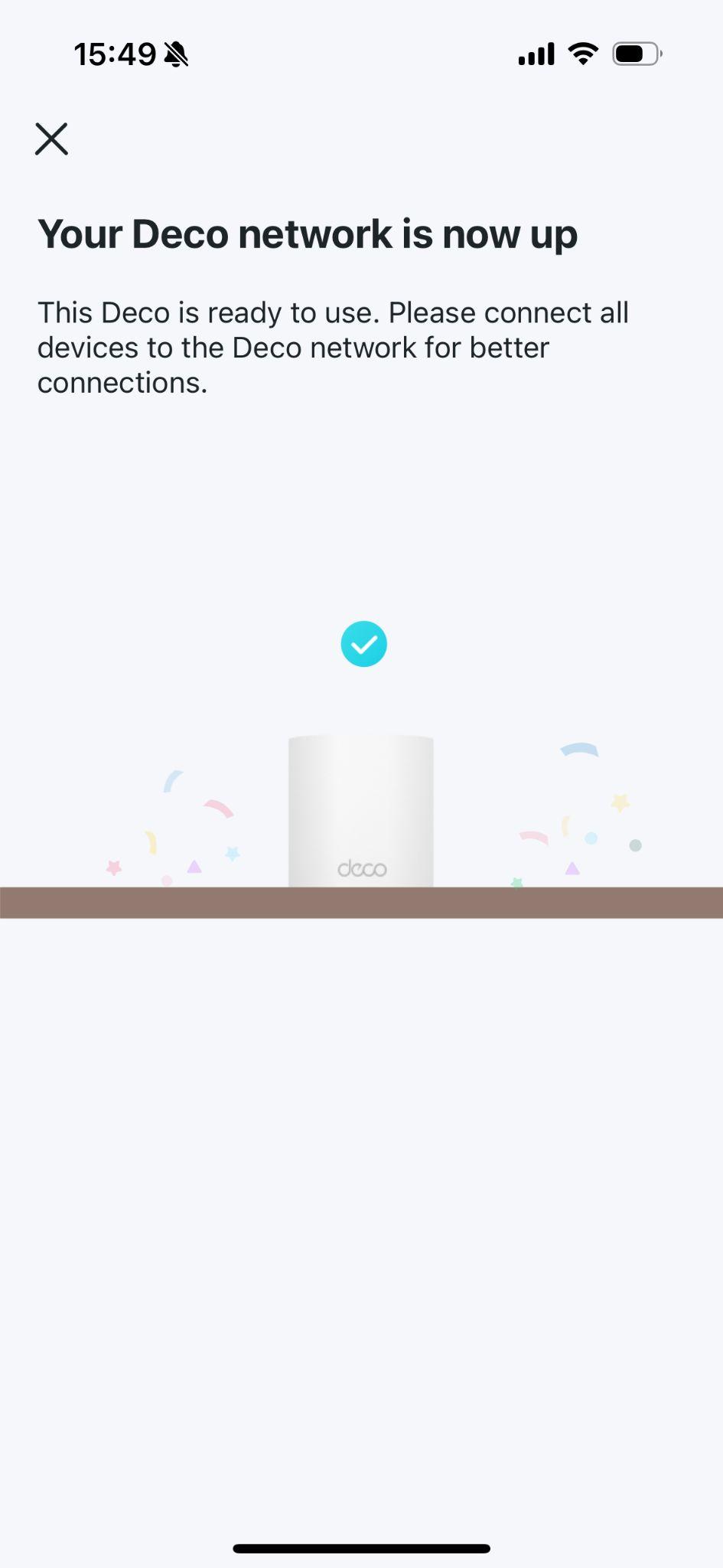 App screen showing "Your Deco network is now up" with a blue checkmark and an illustration of Deco units, indicating the network is ready.