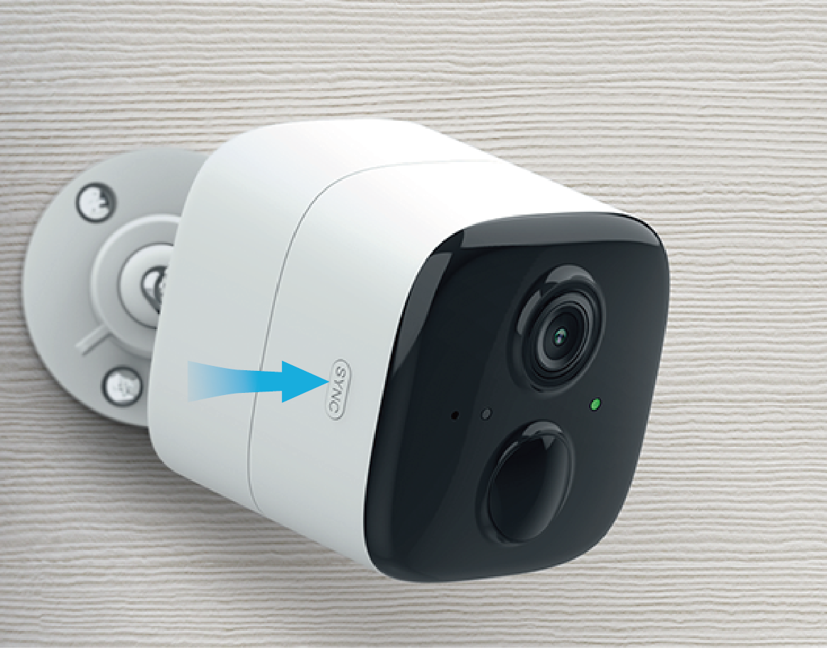 Photo of a Kasa wire-free outdoor security camera mounted on a wall with an arrow pointing to the Sync button on the side.