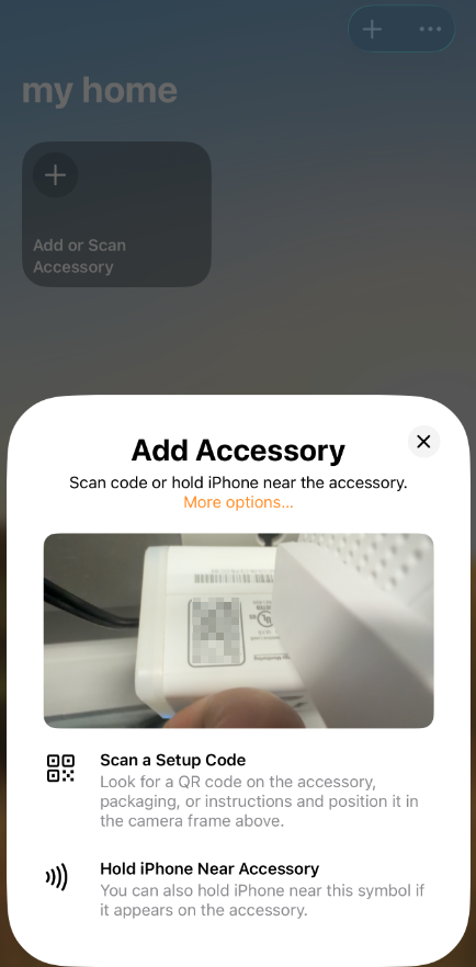Apple Home "Add Accessory" screen showing camera viewfinder and options to scan a QR code or hold iPhone near accessory.