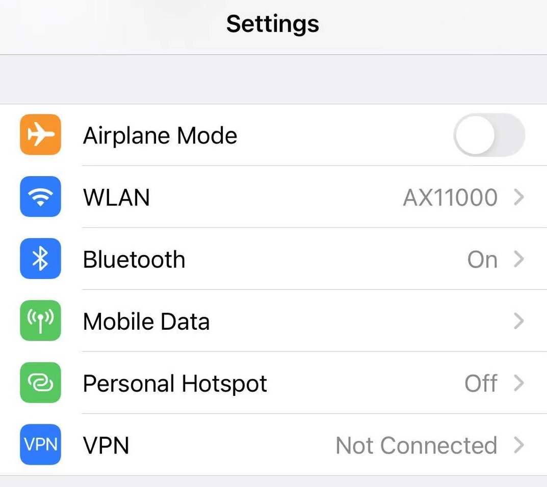 iPhone Settings screen showing WLAN connected to AX11000, with Bluetooth on and VPN not connected.