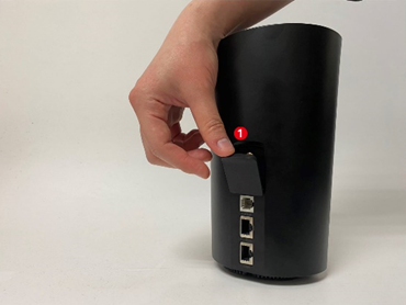 Hand inserting a SIM card into the slot on the side of a black Deco 4G/5G router, labeled step 1.