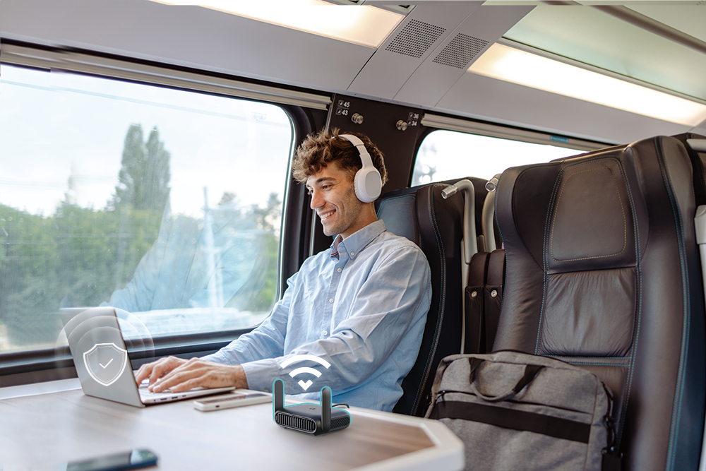 An image displaying a man using the TL-WR1512X portable router during travelling.